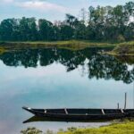 Majuli Island monks walking beside traditional Assamese monastery - digital detox destinations in India